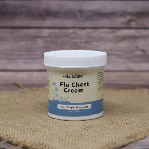 A 6 oz container of Herbal Blessings Flu & Chest Cream, set on rustic burlap with a wooden background.