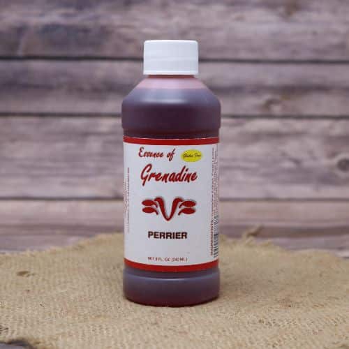 Small 8oz plastic bottle of red liquid with a white and green sticker label, sitting on a burlap material with wood background
