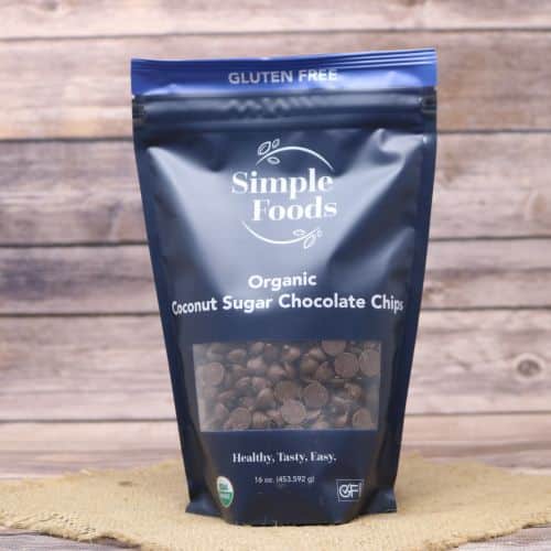 Dark blue bag with a clear plastic window displaying the contents, while sitting on a burlap material with wood background