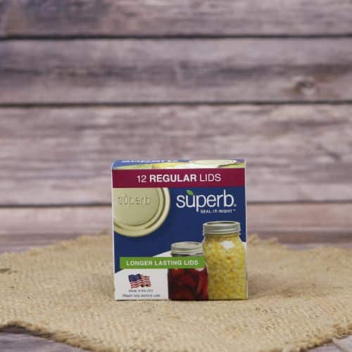 A 12 count box of Superb Regular Canning Lids, on rustic burlap with a wooden background.