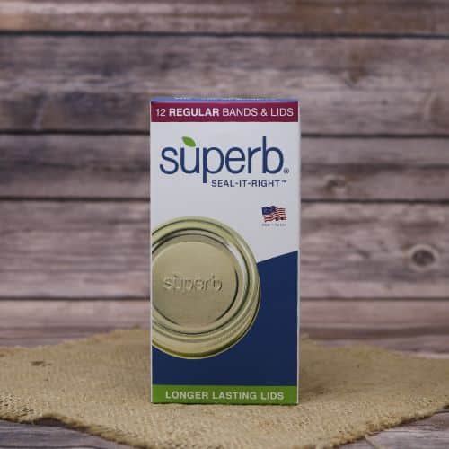 A box of 12 Superb Regular Canning Lids and Bands, on rustic burlap with a wooden background.