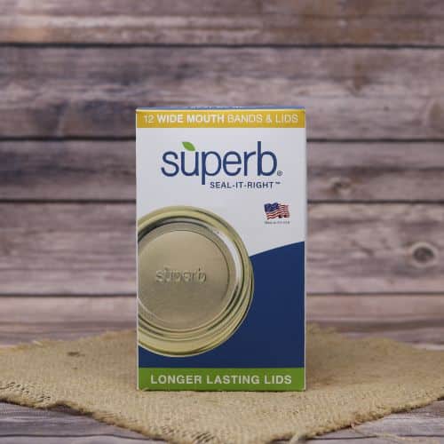 A 12 count box of Superb canning lids & bands, on rustic burlap with a wooden background.