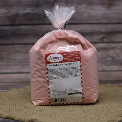 Clear plastic Ashery bag with red and white sticker label filled with a red dessert mix, sitting on a burlap material with wood background