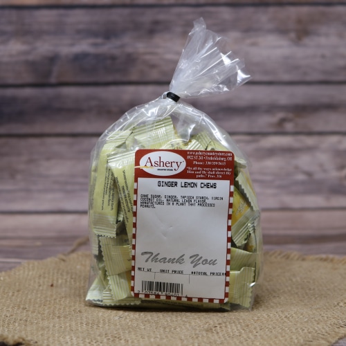 A bag of Ginger Lemon Chews with an Ashery label, set on rustic burlap with a wooden background.