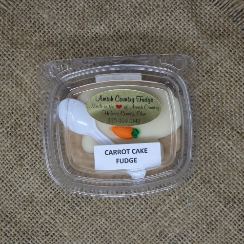 Container of Amish Country Carrot Cake Fudge on a burlap mat.