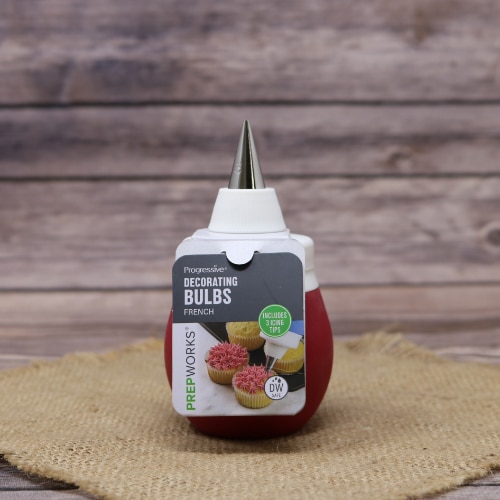 Progressive Prepworks Decorating Bulb with a piping tip on rustic burlap with a wooden background.