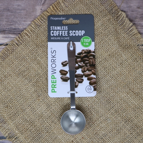 A stainless steel Coffee Scoop, on rustic burlap with a wooden background.