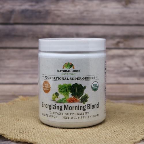 A 30 serving size container of Natural Hope Herbals Energizing Morning Blend greens, on rustic burlap with a wooden background.