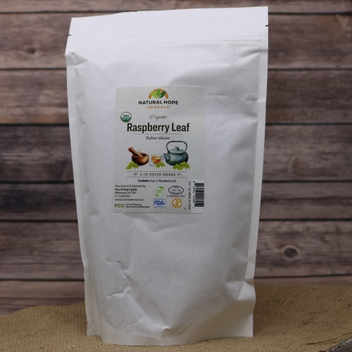 A bag of Raspberry Leaf Tea on rustic burlap with a wooden background.