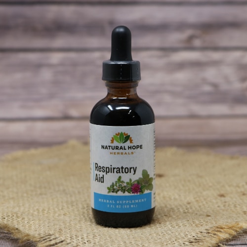 A small glass bottle with a squeeze dropper of Respiratory Aid Supplement on a rustic burlap with a wooden background.