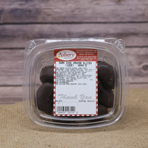 A clear plastic container of Dark Chocolate Orange Slices on a rustic burlap with a wooden background.