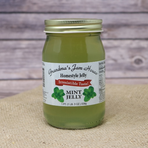 A pint of Grandma's Mint Jelly on rustic burlap with a wooden background.