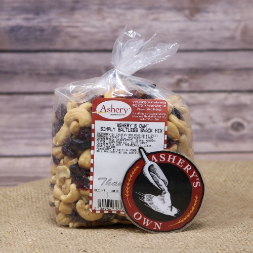 A clear plastic bag of Simply Saltless Snack Mix Ashery's Own on rustic burlap with a wooden background.