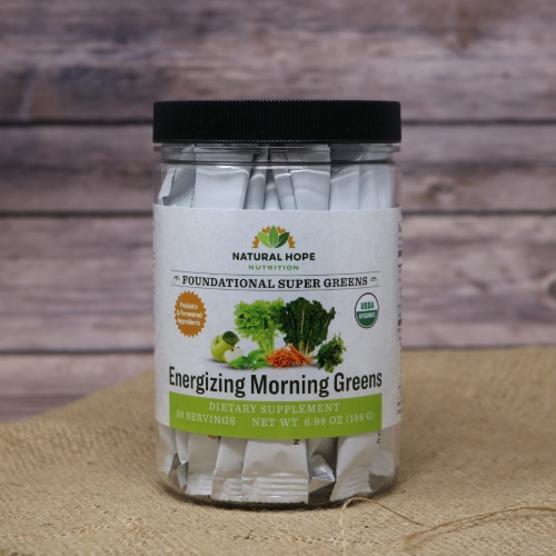 A 30 serving size container of Natural Hope Herbals Energizing Morning Greens, on rustic burlap with a wooden background.