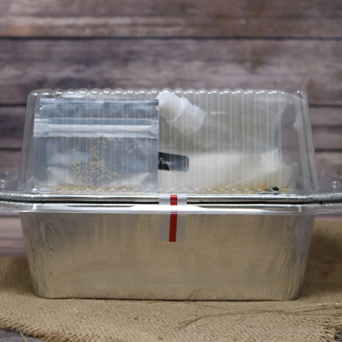 A complete Homemade White Bread Kit With Pan all that is needed to make homemade bread on rustic burlap with a wooden background.