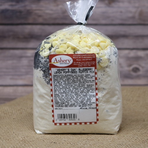 A clear plastic bag sealed with a black twist tie containing Muffin Mix Blueberry Lemon Poppyseed on rustic burlap with a wooden background.