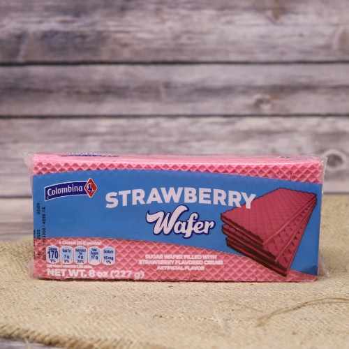 A thin narrow package of Strawberry Wafer Cookies, they are filled with strawberry flavored cream on rustic burlap with a wooden background.