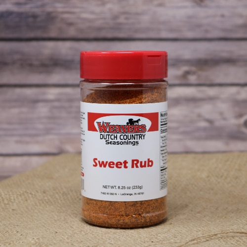A shaker bottle with a red cap of Sweet Rub Seasoning on rustic burlap with a wooden background.